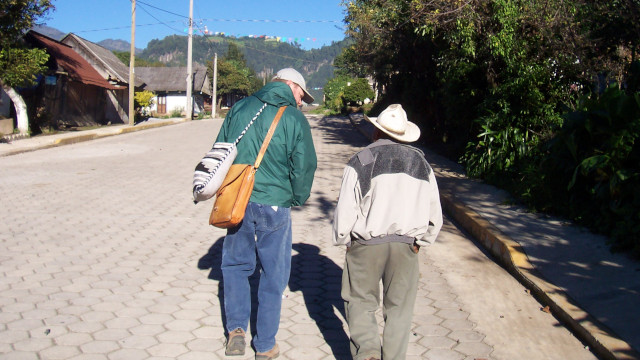 David walking with indigenous man